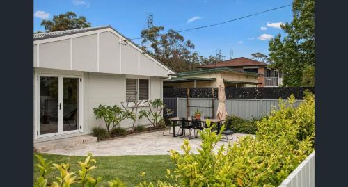 a white house with a patio and a fence at Swell Jervis Bay in Vincentia