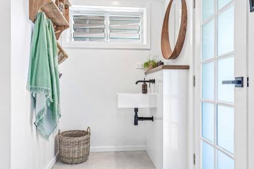 a bathroom with a sink and a mirror at The Beach Hut in Vincentia