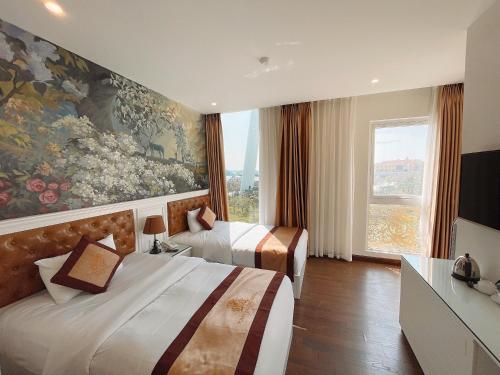 um quarto de hotel com duas camas e um quadro na parede em Pusan Halong Hotel em Ha Long