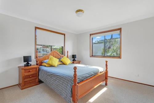 a bedroom with a bed and a window at Beachcombers on Collingwood Beach in Vincentia