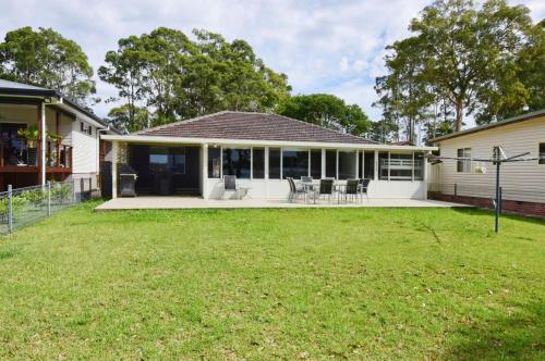 a house with a lawn in front of it at Island Point Paradise in St Georges Basin