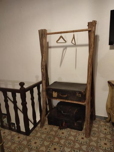 a room with a staircase with a chair and a suitcase at El Escondite de Martina, Áticos Románticos in Setenil