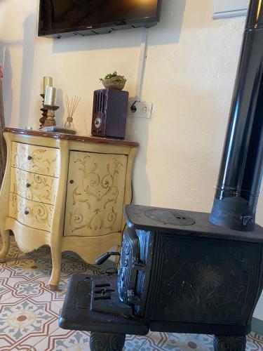 a kitchen with a stove and a stove top oven at El Escondite de Martina, Áticos Románticos in Setenil