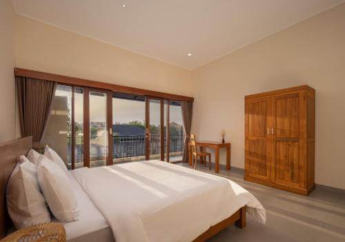 a bedroom with a large bed and a large window at Villa Destino - Seminyak Bali in Seminyak