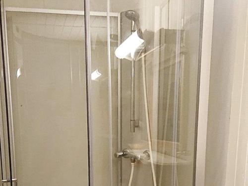 GravdalにあるTwo-Bedroom Holiday home in Gravdal 1のガラスドア付きのシャワー(ライト付)