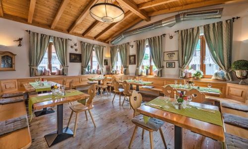 a dining room with wooden tables and chairs at Gasthof Stocker in Landsham