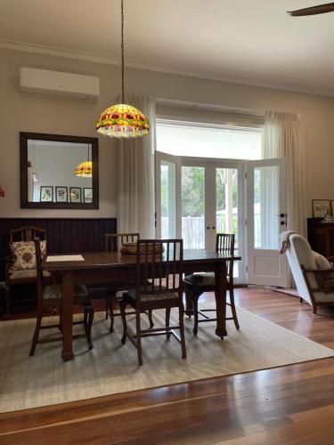 a dining room with a table and chairs at Winniston Lodge Luxury Accommodation in Denmark