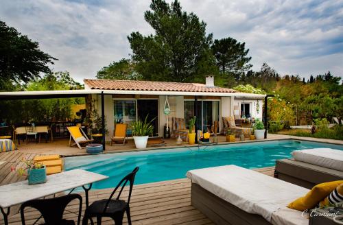 - une piscine avec une terrasse et une maison dans l'établissement B&B La Terre Brûlée, à Aigues-Mortes