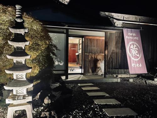 a statue in front of a store with a building at SAMURISE KURA in Fujikawaguchiko