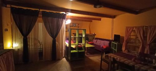 a living room with a room with a table and a couch at Casa Manuel y Ana María. in Llombera