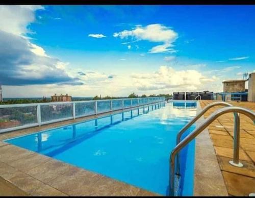 a large swimming pool on top of a building at Josab Super Cosy Apartment. in Kiambu