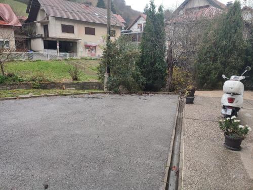 a scooter parked in the driveway of a house at Apartman President in Krapinske Toplice
