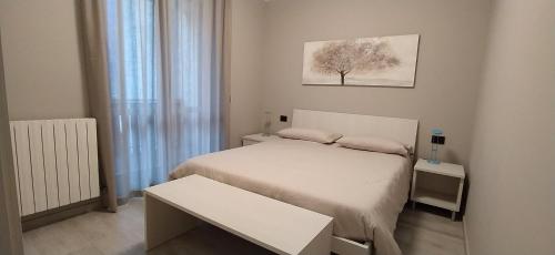 Dormitorio pequeño con cama y mesa en Appartamento Grigna2410 - Primaluna, en Primaluna