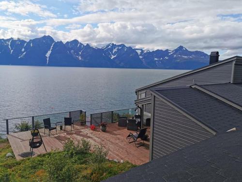 a house with a view of the water and mountains at Lyngen Panorama, Solberget in Storsletta