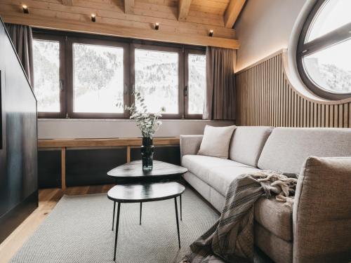 a living room with a couch and a table at The Crystal VAYA Unique in Obergurgl