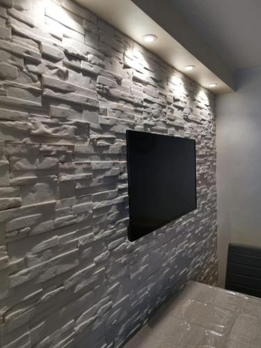 a stone wall with a flat screen tv on it at Belvedere Tonale in Passo del Tonale