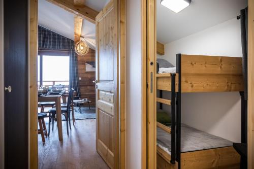 a room with a bunk bed and a dining room at TERRESENS - L'ALTARENA in Les Saisies