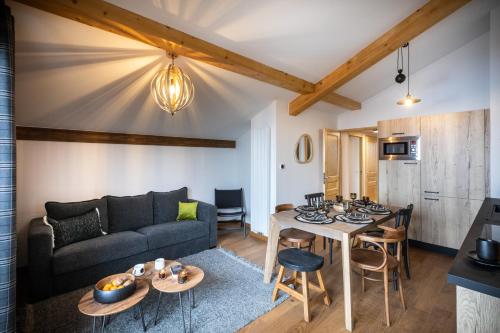 a living room with a couch and a table at TERRESENS - L'ALTARENA in Les Saisies