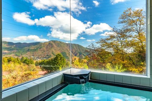 a swimming pool with a view of the mountains at Gora Vacation in Hakone