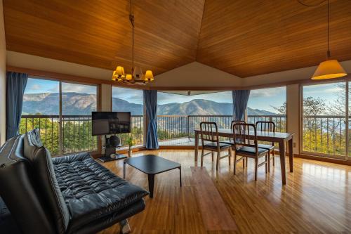a living room with a table and chairs and a view at Gora Vacation in Hakone