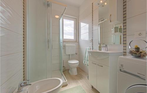 a white bathroom with a sink and a toilet at Cozy Home In Vodnjan With Wifi in Vodnjan