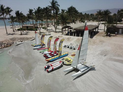 a row of sailboats are lined up on a beach at Hawana Salalah Laguna Studio in Salalah