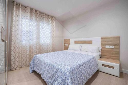 a bedroom with a large bed and a window at Pablo Iglesias in Gijón
