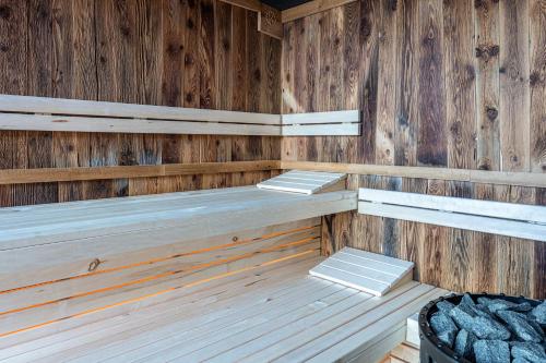 an empty sauna with wooden walls and benches at Spornberg Mountain Living Westberg in Soprabolzano