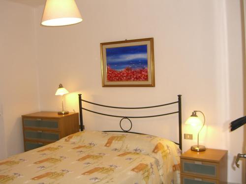 a bedroom with a bed and two night stands and two lamps at La Piazzetta in Sestri Levante
