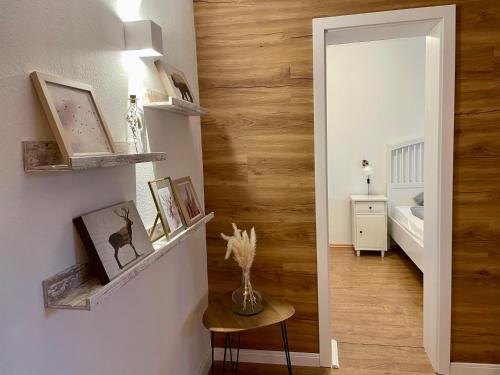 a hallway with a mirror and a room with a bed at Ferienwohnung Clyde in Sankt Andreasberg