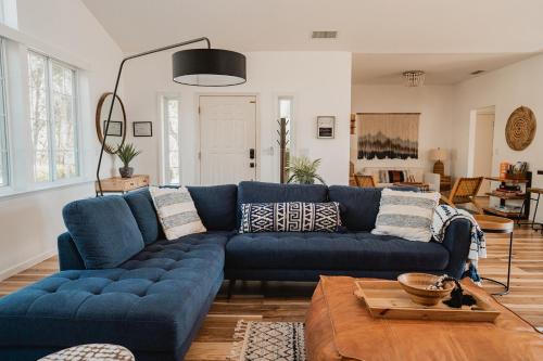 a blue couch in a living room at Glamour Mountain Getaway by Casa Oso with views and spa in Oakhurst