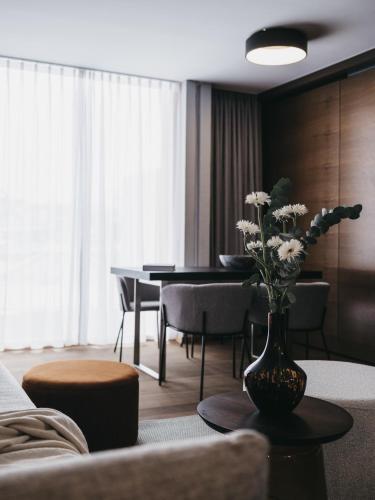 a living room with a vase with flowers on a table at The Crystal VAYA Unique in Obergurgl