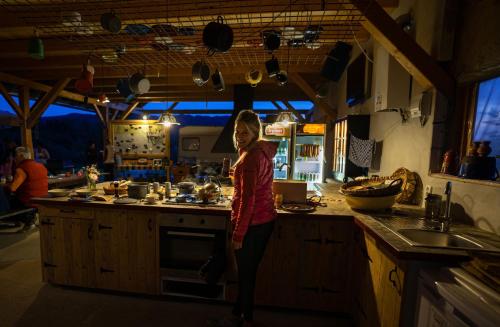 a young girl standing in a kitchen preparing food at Apartment at Sedliacky Dvor - Brezno in Brezno