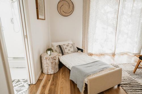 a small living room with a chair and a window at Glamour Mountain Getaway by Casa Oso with views and spa in Oakhurst