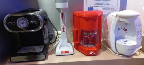 a counter top with a blender and a coffee maker at Captain's Beach Apartments in Limenas