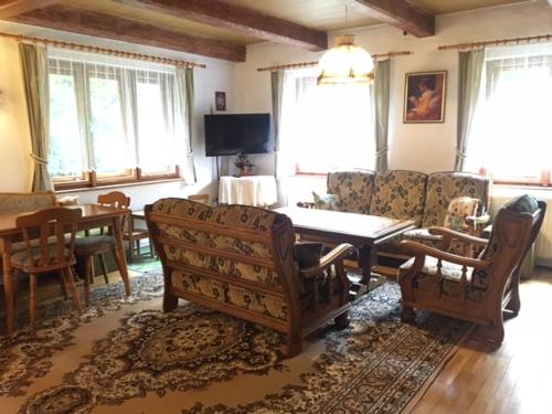 a living room with a couch and a table and chairs at Chalupa Horní Lánov in Dolni Dvur
