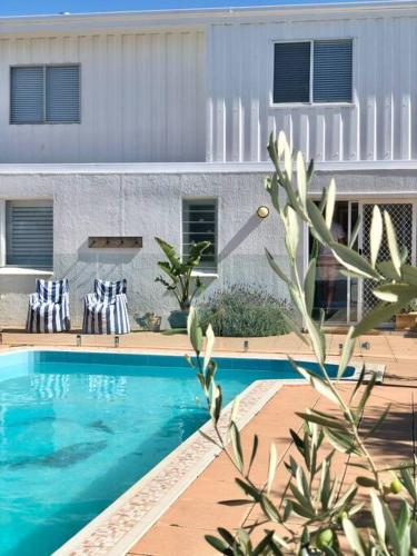 a swimming pool in front of a building at The Landing Aldinga Beach Front Private Pool in Aldinga Beach