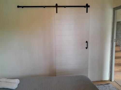 a sliding barn door in a bedroom with a bed at 57 on Plover in George