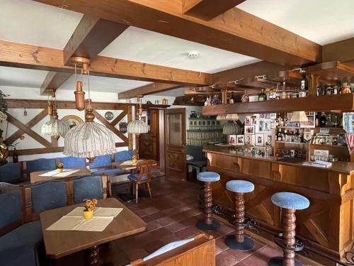 a restaurant with a bar with blue chairs and tables at Gästehaus Deml in Berchtesgaden