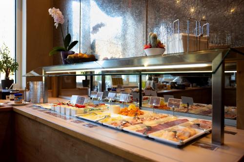 a buffet line with many different types of food at HOTEL junior by MAX 70 in Salzburg