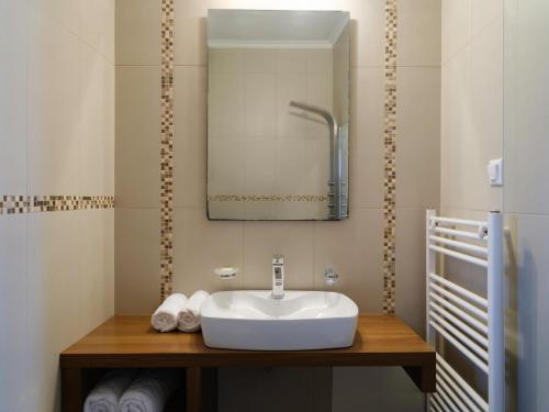 a bathroom with a sink and a mirror at Villa Nikolaos in Elefterna