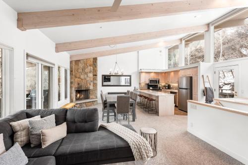 a living room and kitchen with a couch and a table at Standard 2 Bedroom Aspen Alps #407 in Aspen