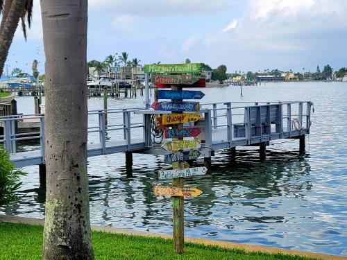 a street sign on a pole next to a pier at Searenity, Waterside studio in the heart of Treasure Island, walk to beach in St Pete Beach