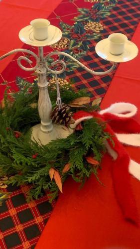 a table with a red table cloth with a christmas centerpiece at Koin Guesthouse Incheon airport in Incheon