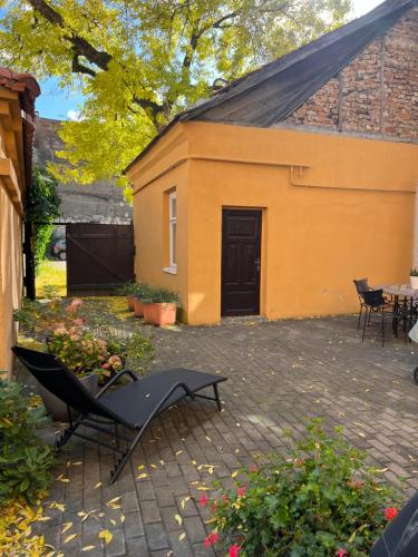 un bâtiment avec une table et des chaises dans une cour dans l'établissement Angel House Vilnius, 4A, à Vilnius