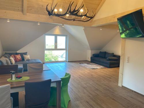 a living room with a table and a couch at Forellenwirt Bacher in Kirchberg