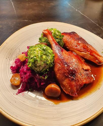a plate of food with meat and vegetables on a table at Hotel Daxer in Kirchberg in Tirol