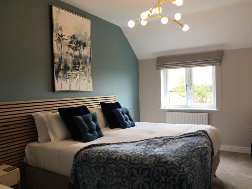 a bedroom with a large bed and a window at Chestnut House, Ashlin Farm Barns in Lincoln