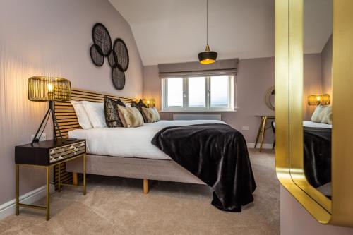 a bedroom with a large bed and a window at The Pines, Ashlin Farm Barns in Lincoln