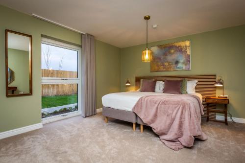 Schlafzimmer mit einem Bett und einem Fenster in der Unterkunft The Willows, Ashlin Farm Barns in Lincoln